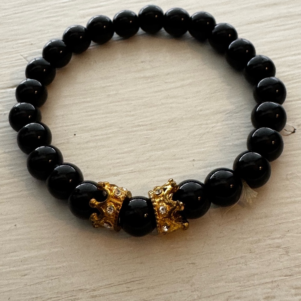 Black bracelet with gold accent crowns
